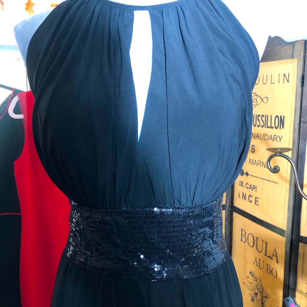 Black sequins evening gown with split in the front of the dress size 14W.